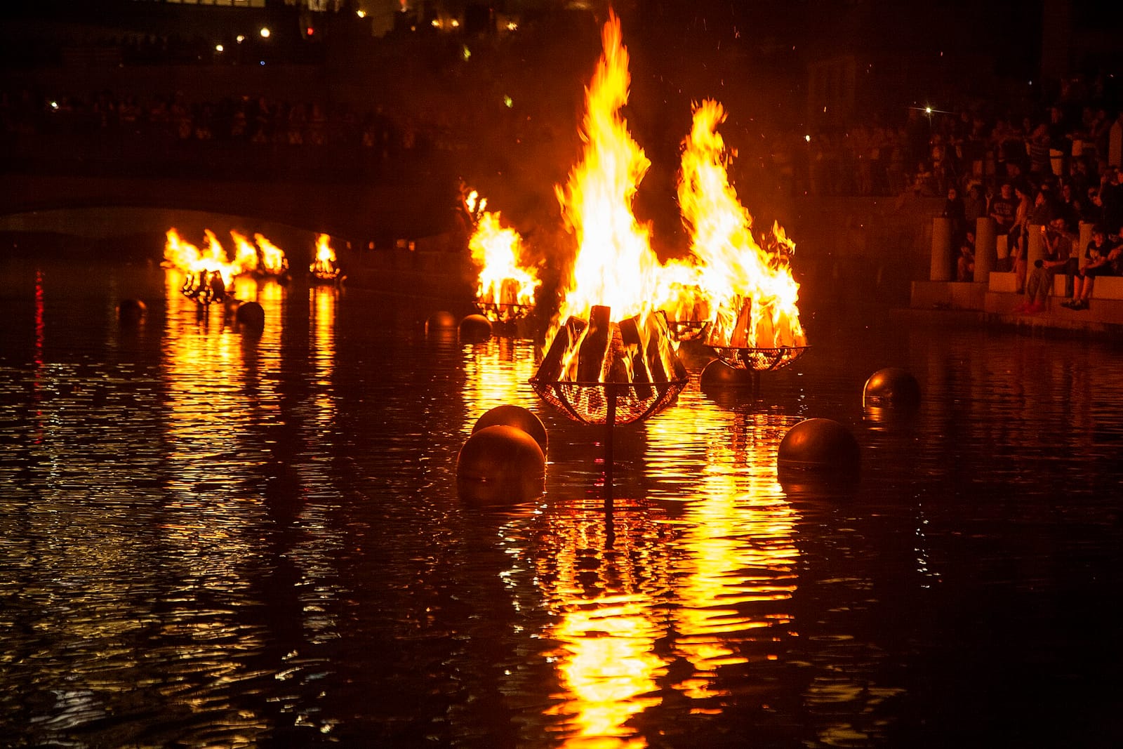 WaterFire braziers burning along the Providence riverfront at night in an archival 2015 photograph